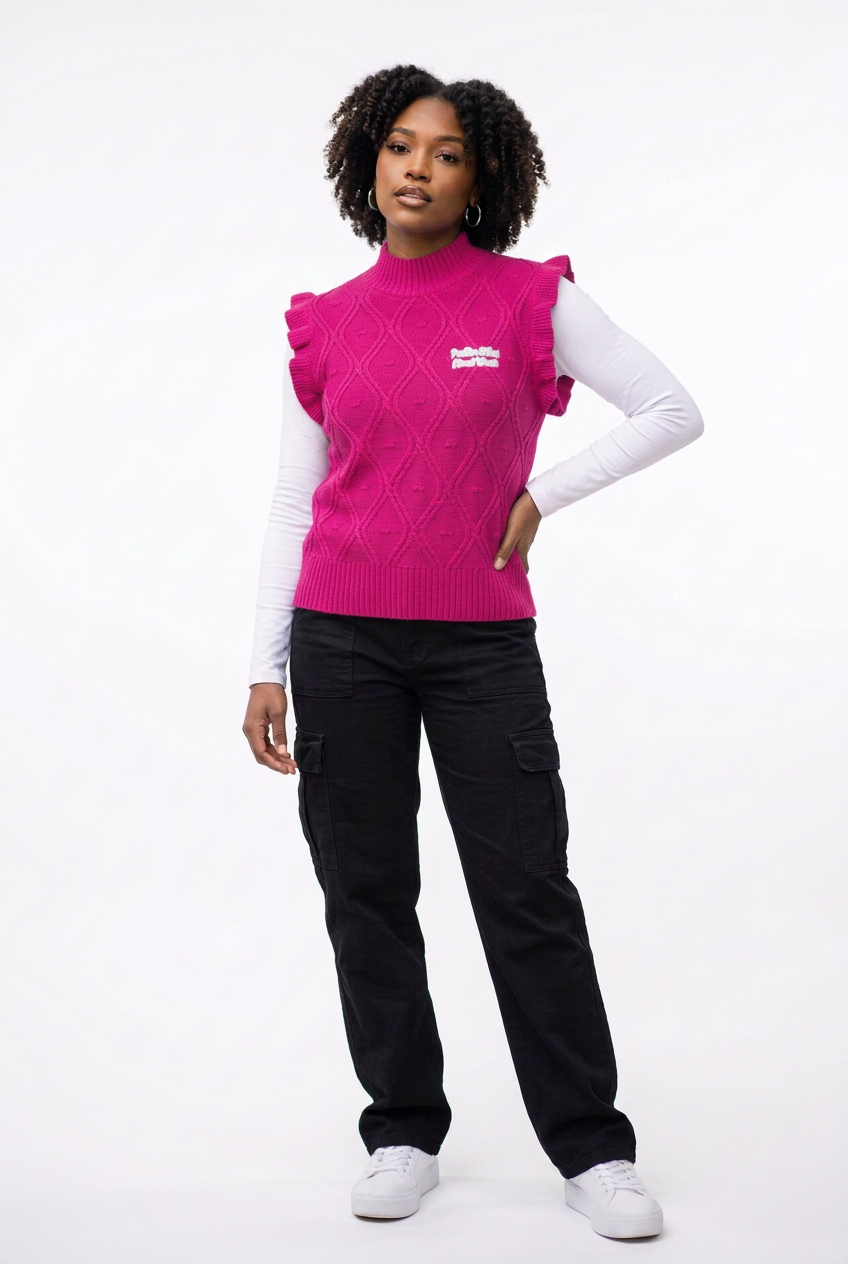 Model wearing the pink vest with streetwear styling on a white background