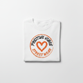 Positive Vibes Logo Tee Folded on White Background